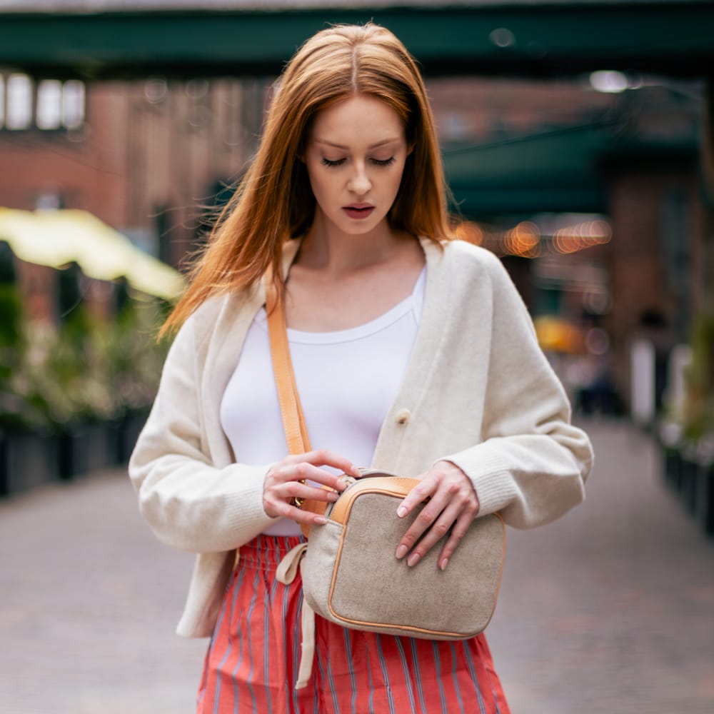 Woman carrying the Natural Italian Wool Crossbody Bag in Toronto's Distillery District