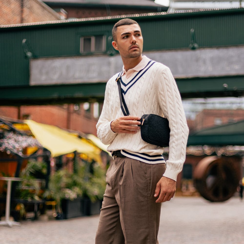 Man carrying the Black Italian Wool Crossbody Bag in Toronto's Distillery District