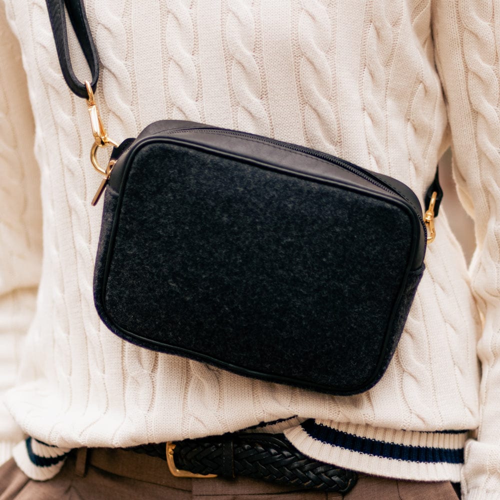 Close-up of a man carrying the Black Italian Wool Crossbody Bag in the Distillery District